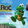 Croc from Croc Legend of the Gobbos remaster jumping in a colorful 3D platforming scene with platform logos and Coming Soon text