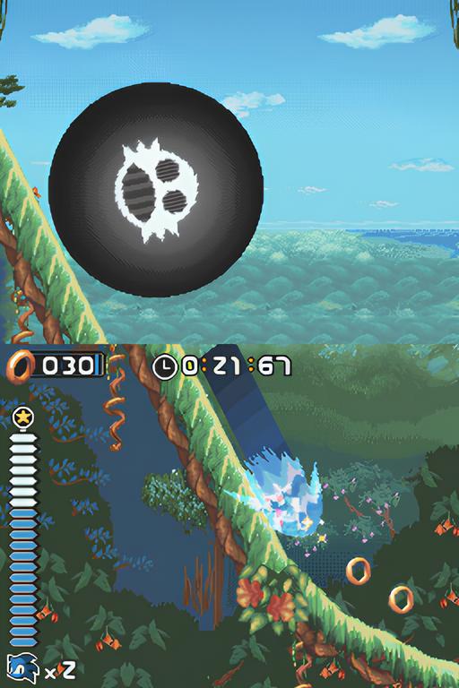 Sonic Rush gameplay showing a giant Eggman-branded boulder rolling down a hill on the top screen, while Sonic boosts away on the bottom screen.