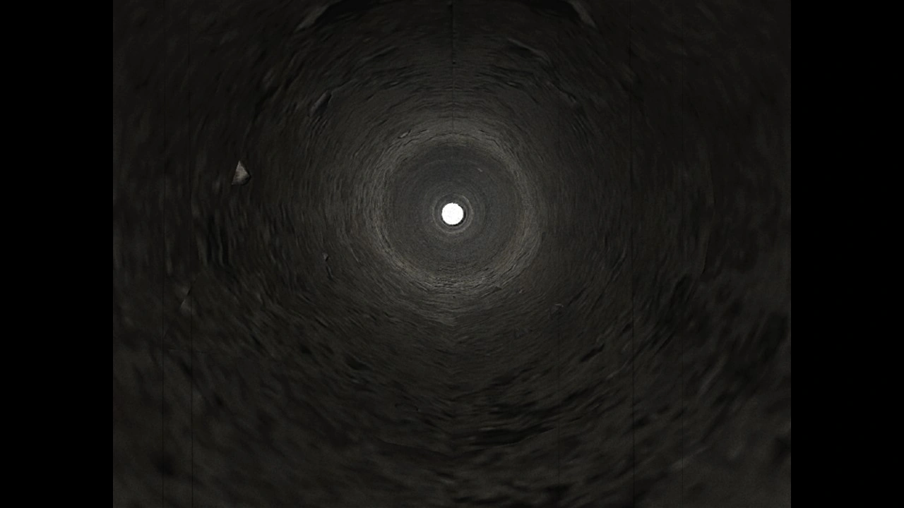 Tunnel view with white light at the far end, symbolizing a shift into the otherworld’s surreal spaces.