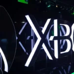 Xbox logo glowing white in 3D, featured image for Xbox layoffs article