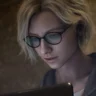 Grace Ashcroft using a laptop in Resident Evil Requiem, highlighting the game’s realistic character models and tense atmosphere
