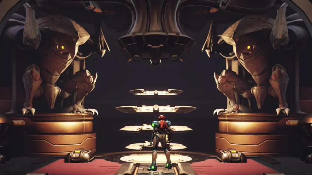 Samus standing in a Save Station, flanked by two large, imposing statues in Metroid Dread.