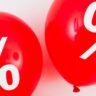 Red balloons featuring percentage symbols, ideal for sales and promotions. Black Friday 2025.