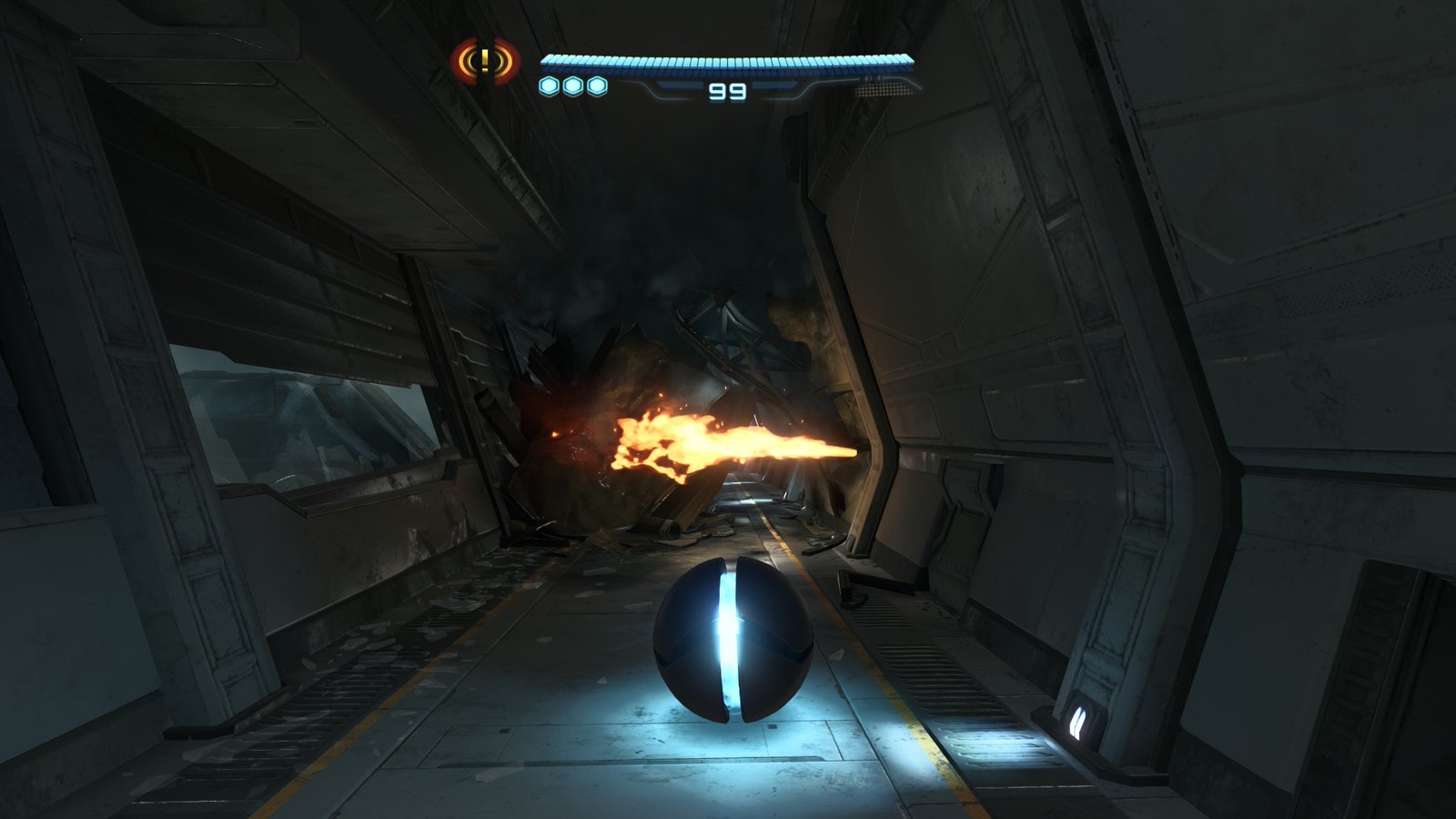 The Morph Ball rolling down a damaged metallic corridor past a jet of fire.