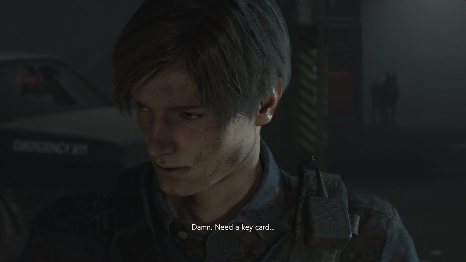 A close-up of Leon S. Kennedy in Resident Evil 2 Remake looking frustrated with the subtitle "Damn. Need a key card..." during a gameplay sequence.
