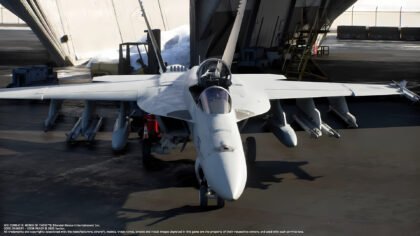 In-engine imagery from **Ace Combat 8 Wings of Theve** showing the protagonist's F/A-18E Super Hornet carrier-based fighter in a hangar bay.