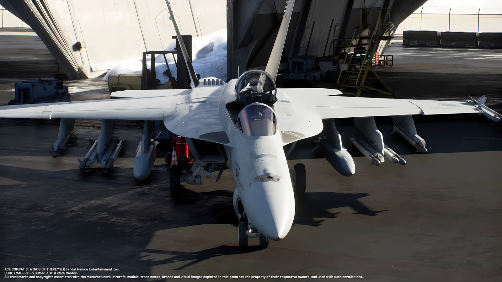 In-engine imagery from **Ace Combat 8 Wings of Theve** showing the protagonist's F/A-18E Super Hornet carrier-based fighter in a hangar bay.