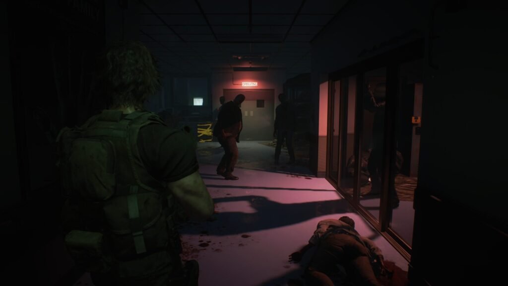 Carlos Oliveira in a dark hospital hallway illuminated by a glowing red "OPERATING" sign with zombies standing in the shadows.
