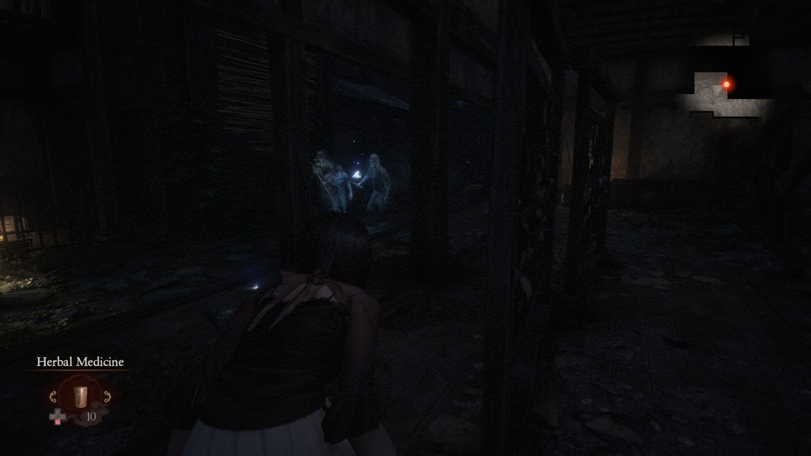 Mio crouching in the shadows behind a wooden partition to evade wandering spirits in a dark house hallway.