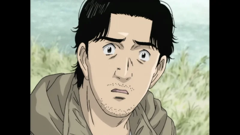 Blu-ray screenshot of a shocked Kenzo Tenma outdoors.