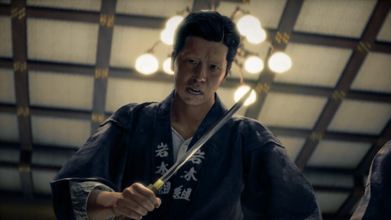 Character Suekichi holding a drawn katana blade under a chandelier in Stranger Than Heaven.