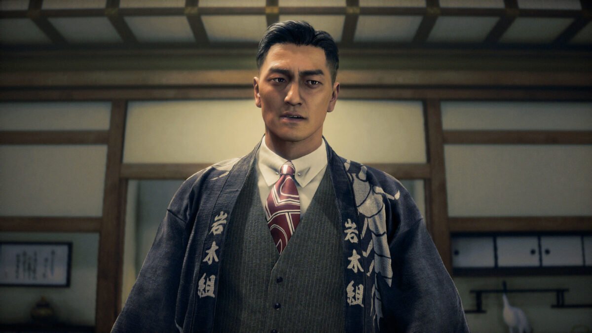 Tetsuya Hama wearing a formal vest and tie under a dark robe in Stranger Than Heaven.