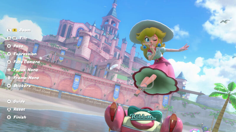 Princess Peach posing on a kart at Peach Resort inside the updated Photo Mode interface.