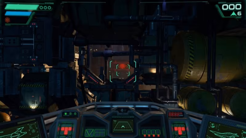 First-person cockpit view in Star Fox Switch 2 remake showing green digital displays and a targeting reticle inside a dark industrial facility corridor.